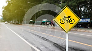 Yellow sign with graphic of bicycle to warn traffics to beware of bicycle lane