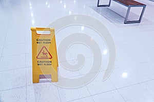 Yellow Sign showing warning of caution wet floor