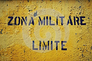 Yellow sign 'Zona Militare Limite' in italian city Gaeta. photo