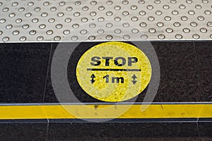 yellow signage on the floor with circle and yellow line during the covid-19 pandemic