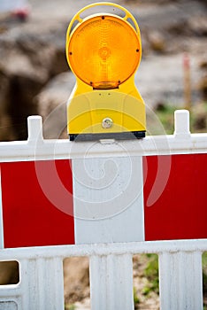 Yellow signal lamp on construction site