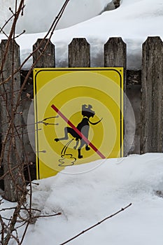 Yellow Signboard: a Signal Prohibiting Dog Excrements near Fresh Snow