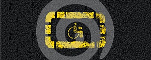 Yellow signs handicapped spot on tarmac road top view