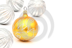 Yellow and silver christmas ball on white