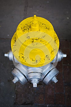 Yellow and silver fire hydrant on the street