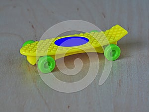 Yellow skateboard with green whells photo