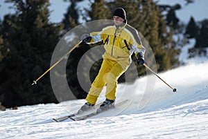 Yellow skier on ski slope