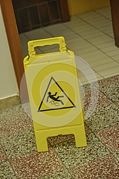 Yellow slippery floor sign, indoors