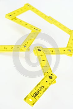 Yellow small folding ruler on white background