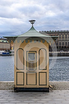 Yellow small newsstand in front of the Royal palace in Stockholm