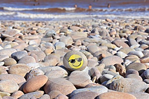 Yellow smiley face painted on the stone