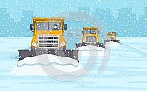 Yellow snow plow convoy clearing the highway. Winter driving conditions.