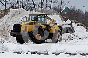 yellow snow plow tractor