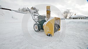 Yellow Snow thrower, winter time, moving camera