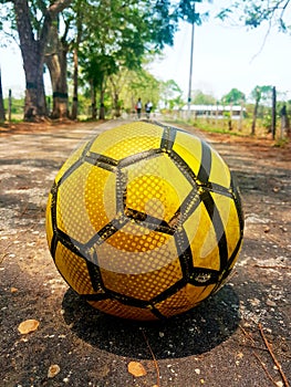 Yellow soccer ball on road to happiness photo