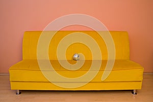 Yellow sofa with small discoball photo