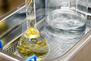 Yellow solution in the flask and beaker for dissolving or extraction into ultrasonic bath. Urea analysis. Clinical