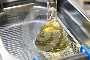 Yellow solution in the flask for dissolving or extraction into ultrasonic bath. Urea analysis. Clinical, toxicological