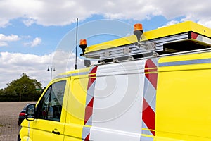 Yellow special cargo escort road traffic car roof mounted digital sign board. Repair and service van with ladder and