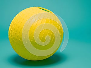Yellow Sphere With Grid Pattern On Teal Background