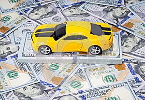 Yellow sport car on american dollars money background