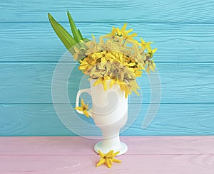 Yellow spring flowers easter vintage border seasonal on blue wooden background