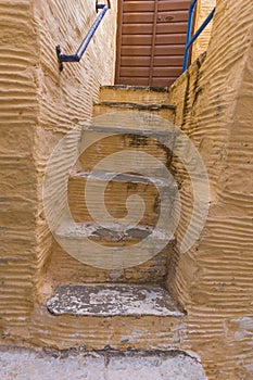 Yellow staircase in old town of Ermopoli, Syros, Greece