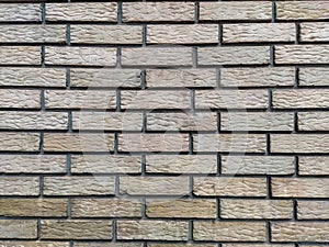 Yellow standard bricks found on building walls with even pattern and rough texture, cool wallpaper or background of a wall