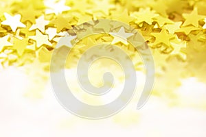 Yellow star background. Festive glitter background with defocus lights