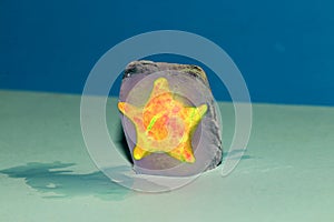 a yellow star in an ice cube on a blue background
