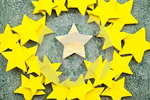 Yellow star with one wood star in middle standing out farther than the rest