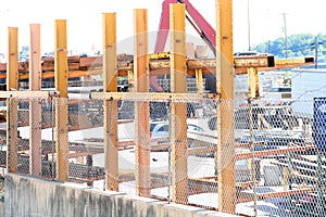 Yellow steel beams fence off a scrap yard