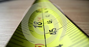 Yellow steel construction tape close-up. Measuring length and distance ruler
