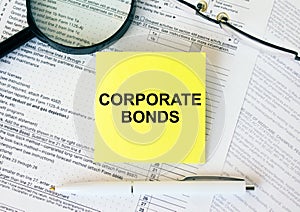 Yellow sticker with text Corporate Bonds on financial docs