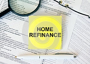 Yellow sticker with text Home Refinance on financial docs