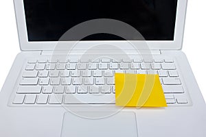 Yellow Sticky Note Post on White Laptop.