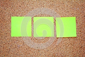 Yellow sticky notes on a cork board