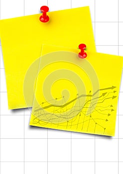 Yellow sticky notes with yellow graph against white graph paper
