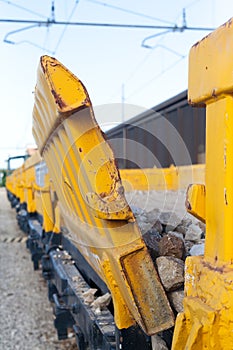 Yellow stone transport freight train wagon in railway depot