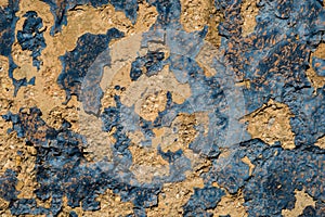 Yellow stone wall with dark blue paint pealing off/grunge wall t