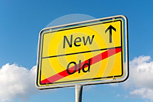 Yellow street sign with New ahead leaving Old behind