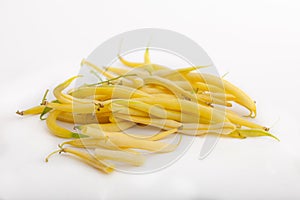 Yellow string beans on white background.