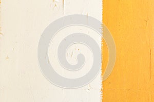 A yellow stripe on a white wall. The wall of the house is painted with white and yellow paint