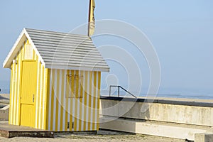 Yellow striped hut next to the Esmoriz beach in Portugar