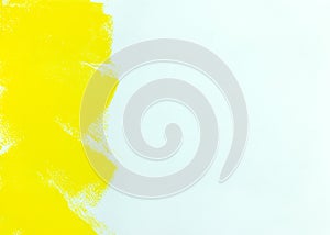 Yellow strokes of paint roller on white wall