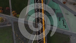 Yellow Subway Train on bridge passing public Park in Berlin, Germany, Aerial Birds Eye Overhead Top Down perspective