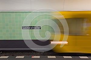 Yellow subway train in motion on Berlin Alexanderplatz underground station.