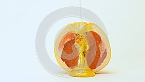A yellow sugar paste for epilation is poured on top of a grapefruit. Hair removal concept