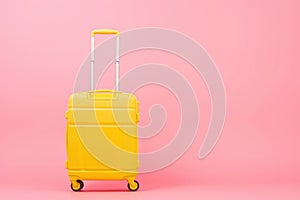 a yellow suitcase is sitting on a pink background