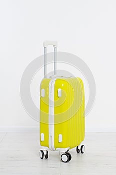 Yellow suitcase on white background .Summer holidays. Travel valise or bag. Mock up. Copy space. Template. Blank.
